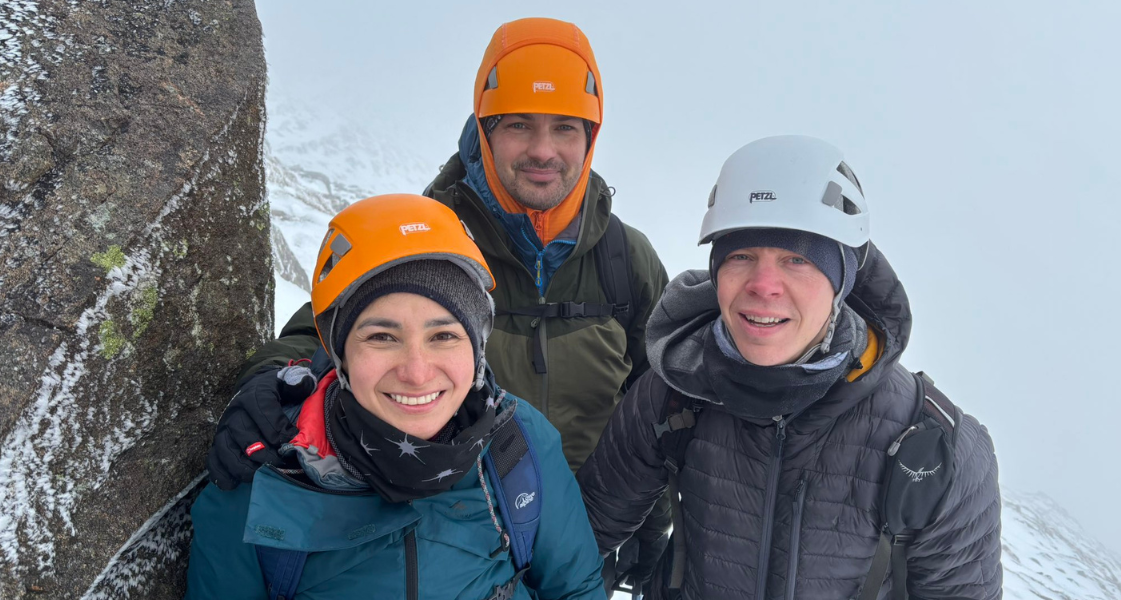 A group of people in the snow wearing safety equipment on Helvellyn