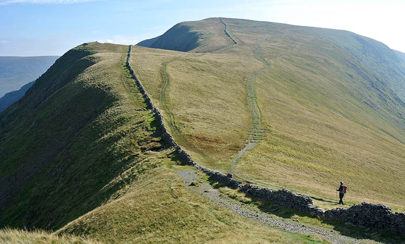A walker on a Roman road in the high fells, High Street, Lake District