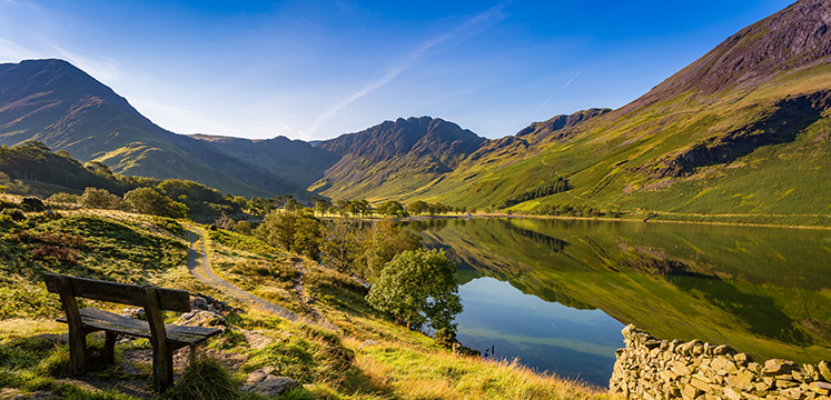 Buttermere lake shore with a wooden bench