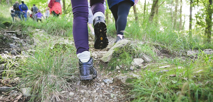 Close up photo of walking boots on a path.