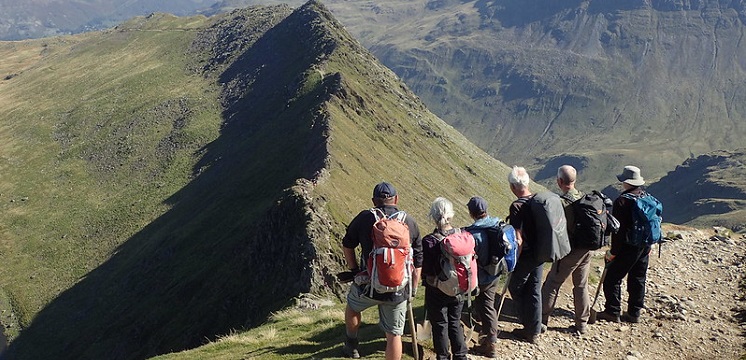 A photograph showing Fix the Fells volunteers enjoying a scenic view of Lake District Fells