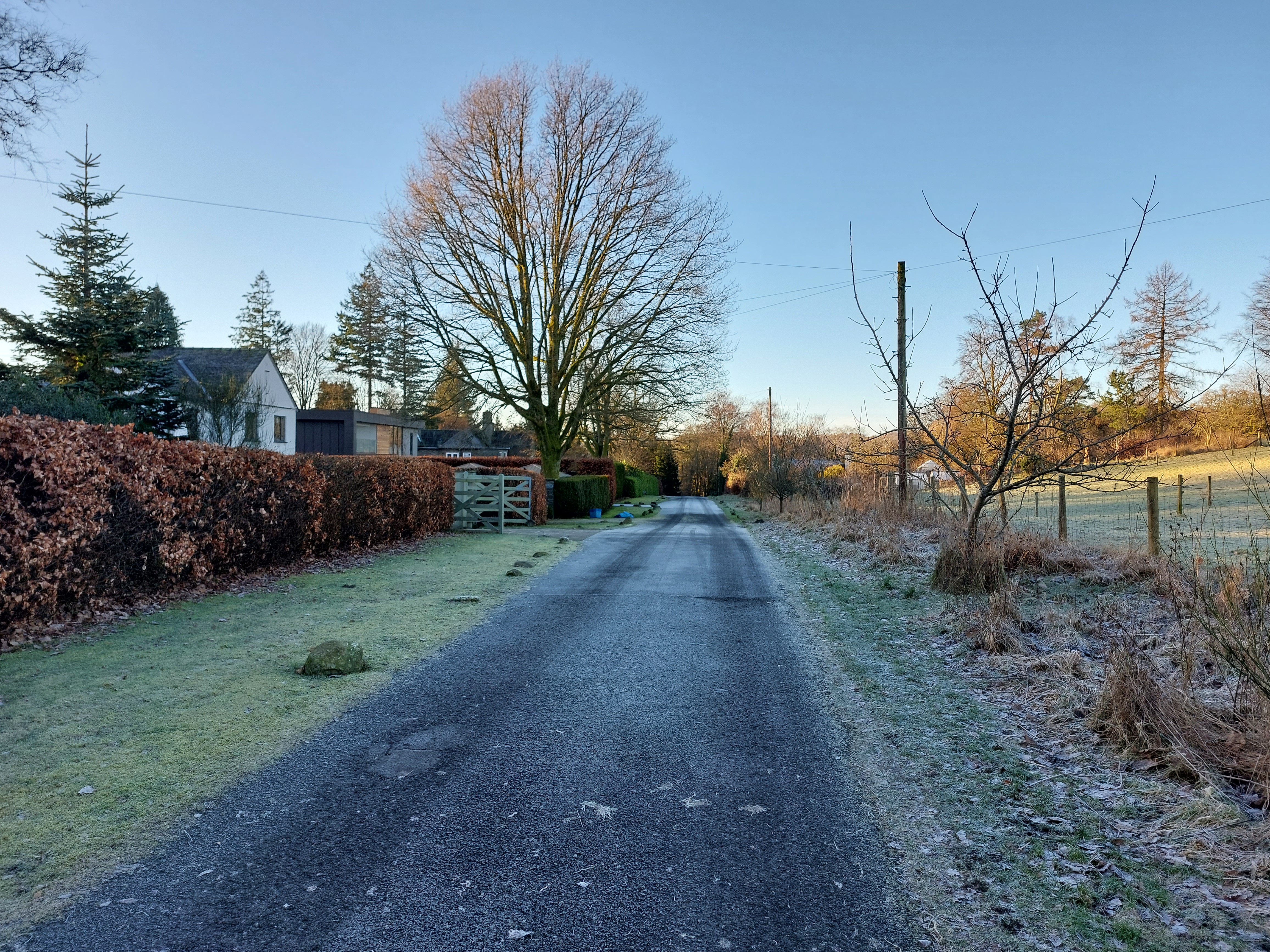 The view of the hillside is an attractive terminal feature of this  suburban street. Ambleside.