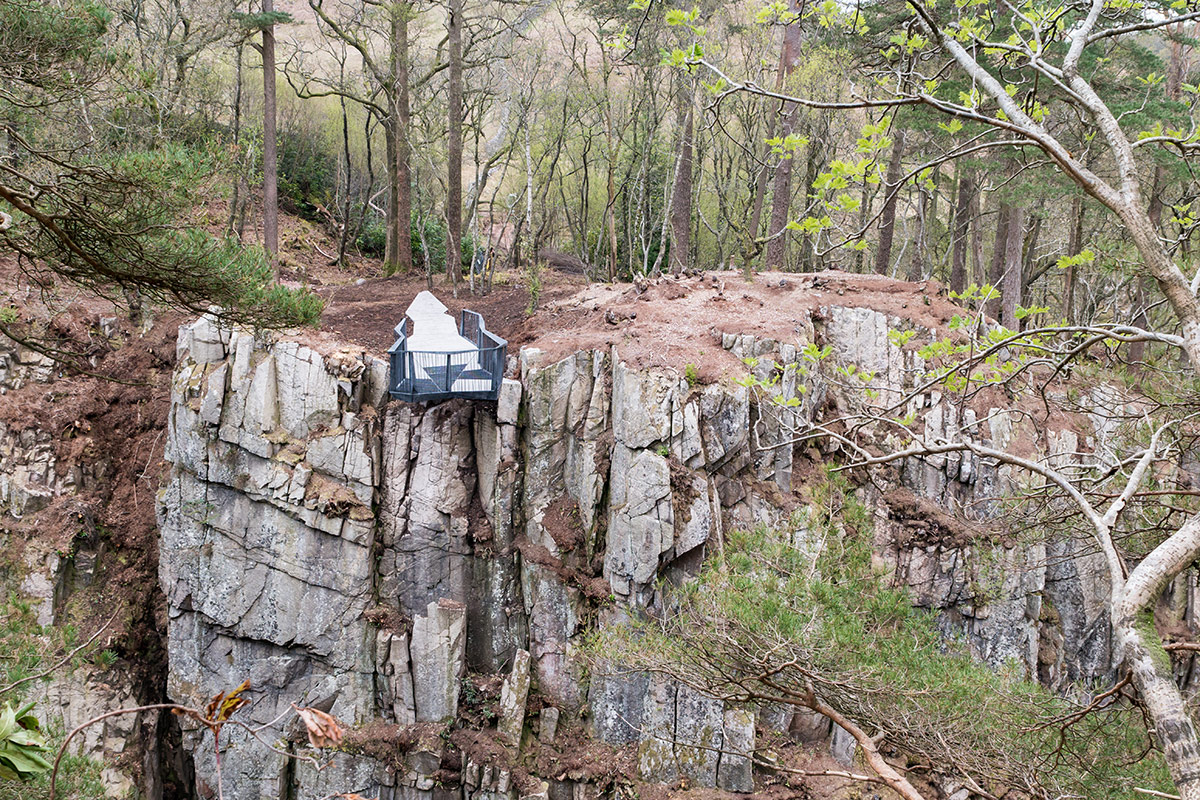 View across a steep sided ghyll to a metalwork viewing platform.