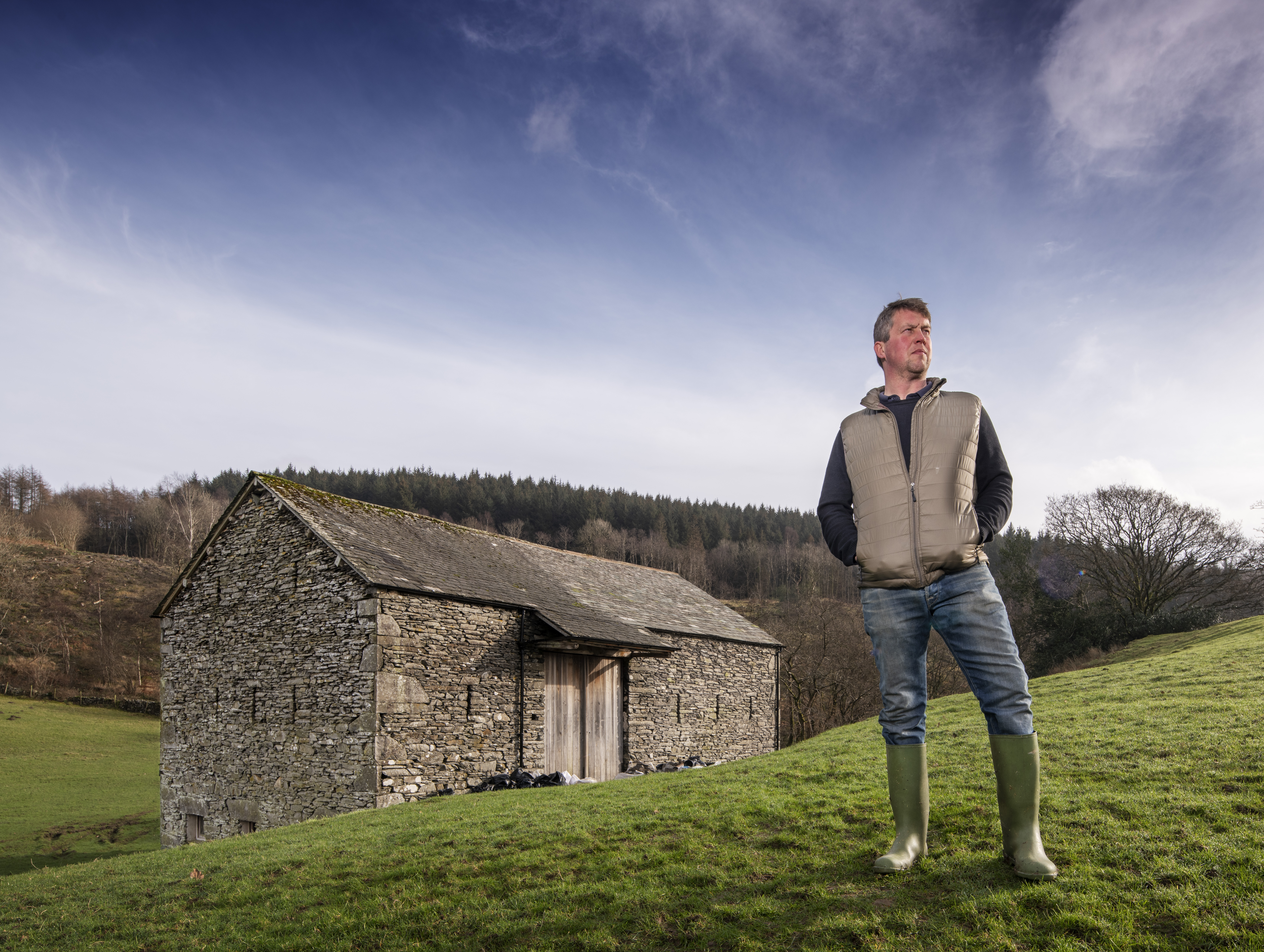 Farmer Keith Hodgson stood in front of repaired Lake District Bank Barn