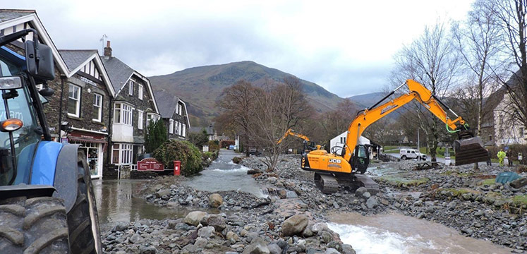 Diggers repairing flood damage in Glenridding