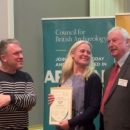 the Lake District National Park’s Eleanor Kingston receiving the Council for British Archaeology’s Community Award from Richard Osgood, Archaeologist and Charles Micklewright, Trustee of the Marsh Christian Trust.