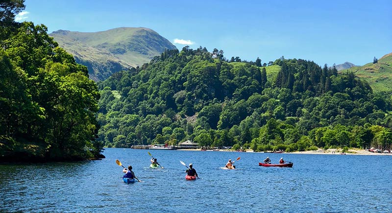 Kayaking on Ullswater lake with mountains in the background