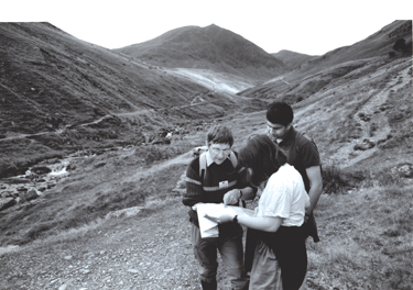 Ranger helping walkers above Greenside Mines