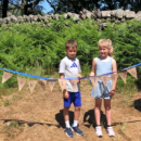 two children standing behind bunting that spells out Eskdale Trail 