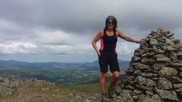 Woman on a Lake District fell summit. 