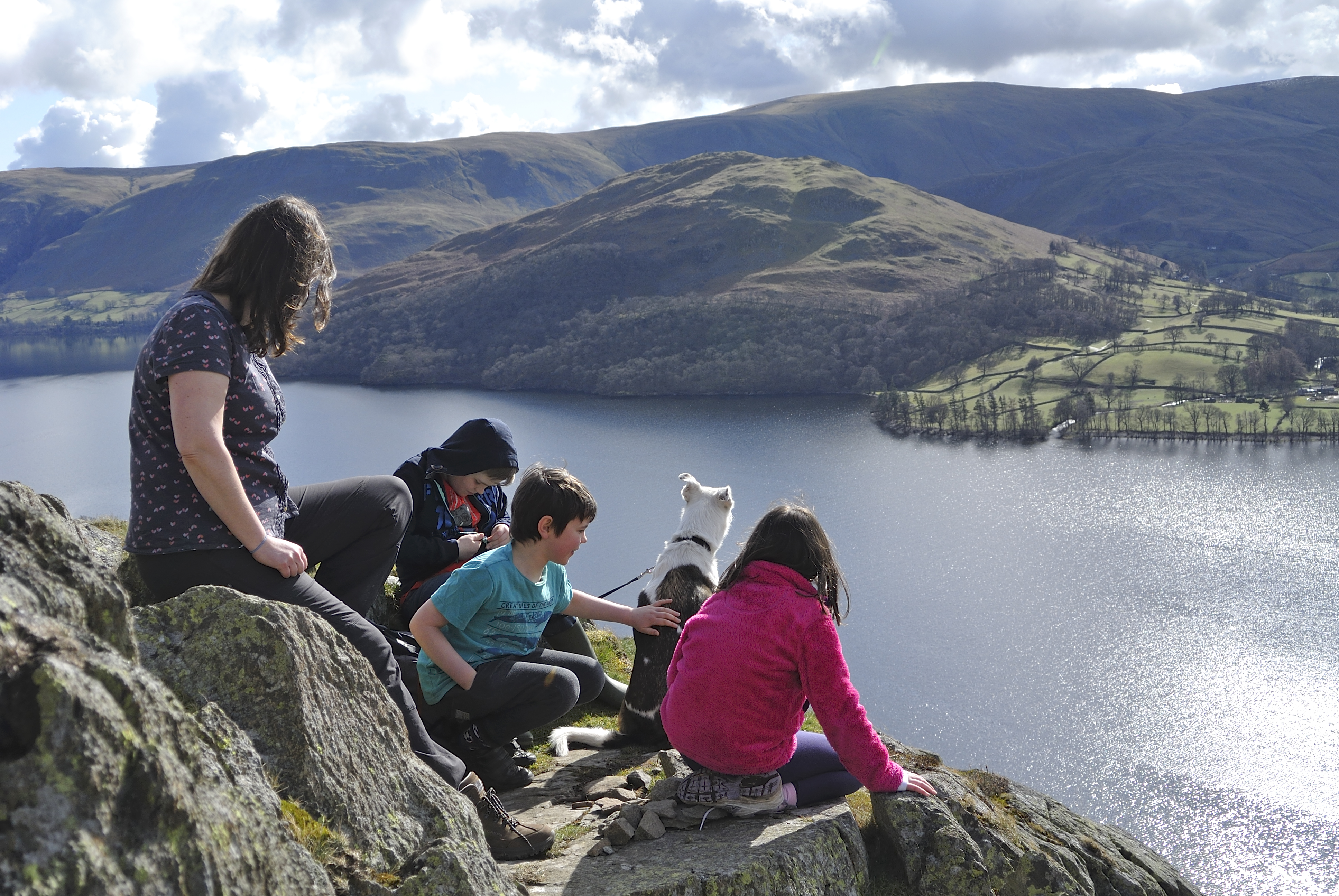 People overlooking lake in the Lake District National Park