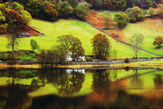 A cottage reflecting of Coniston Water