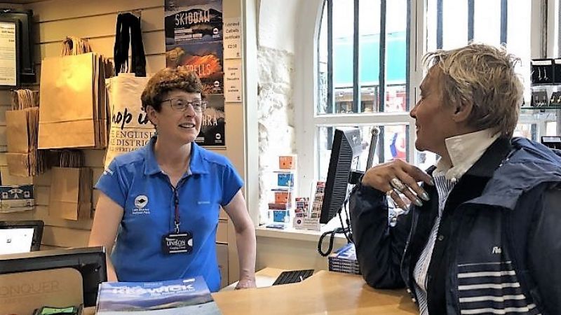 Customer Adviser talking to customer in an Information Centre