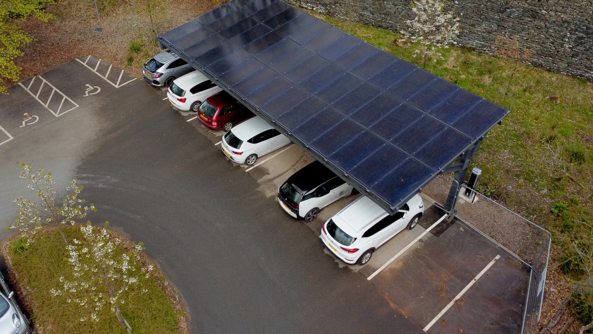 Solar panels at an electric car charging area - Adrian Naik