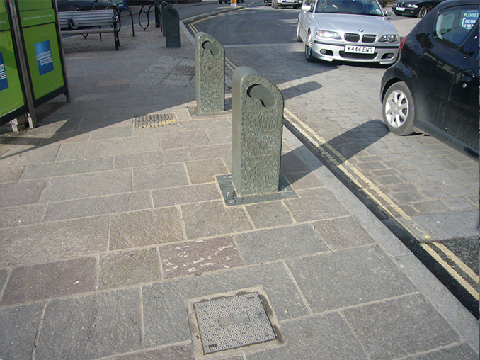 Bollards on a stone flag pavement in Windermere.